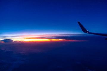 Clouds and sky as seen through window of an aircraft