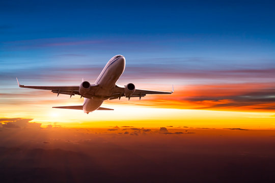 Airplane in the sky at sunrise