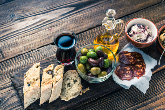 Authentic spanish tapas on wooden board, tonned picture