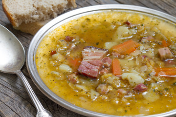 Split pea soup on vintage wooden table
