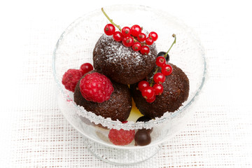A delicious dessert with chocolate cake balls and fresh berries