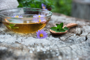 Spa and wellness setting with sea salt, oil essence, flowers and