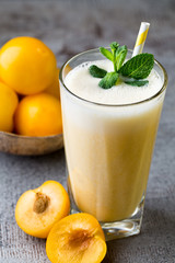 Plum smoothie, on the grey  background.
