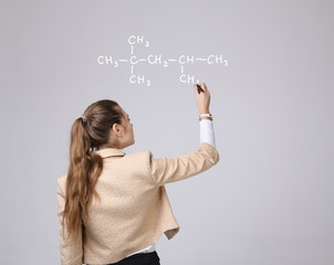 Woman chemist shows a molecular structure