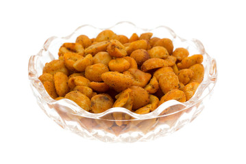 Portion of hot and spicy peanuts in a glass bowl isolated on a white background.
