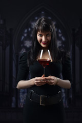  woman in black with red wine