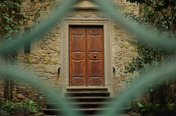 Vintage green door in the old building in Florence