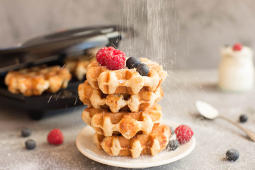 Homemade Belgian waffles with forest fruits,  blueberries, raspberries and 
yogurt. Vintage styling. Toning.