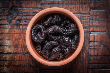 Prunes in clay bowl 