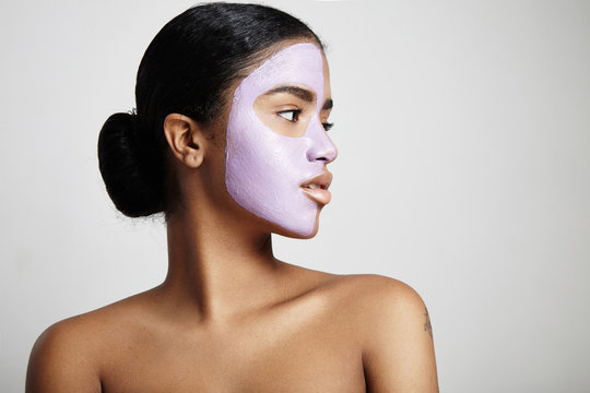 woman with a facial mask looks aside