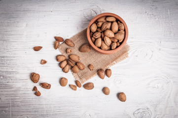 Tasty almonds in bowl rustic wooden table
