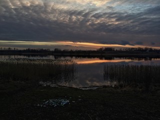 Trash near lake at sunset