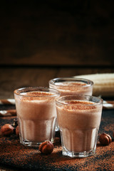 Banana chocolate smoothie with nuts, dusted with a powder, healt