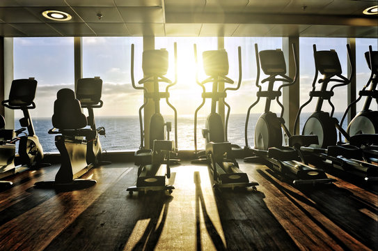 elliptical cross trainer in a row in a gym on a cruise liner wit