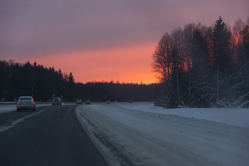 cars in the road, winter at sunset