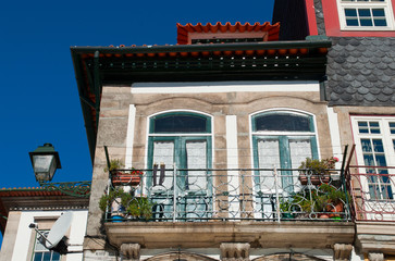 Fragment of a cute traditional house with a balcony in the old town. Porto, Portugal