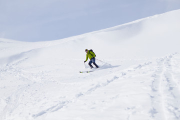Naklejka na ściany i meble skier going down of a mountain