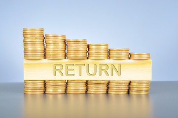 Stack of golden coin with word written on wood