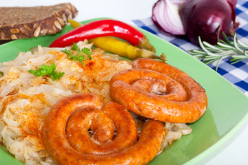 Traditional fried sausage and sauerkraut on a plate