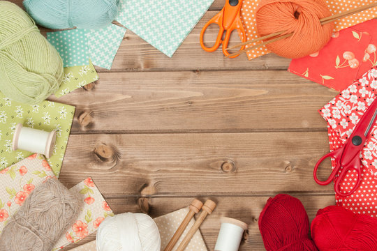 Sewing And Knitting Accessories. Fabric, Yarn Balls. Wooden Tabl