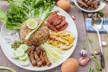 Rice maxed with shrimp paste is Thai Food ingredients are rice, shrimp paste, shallots, chili, fried egg, sweet pork, cucumber, sausage and mango.
