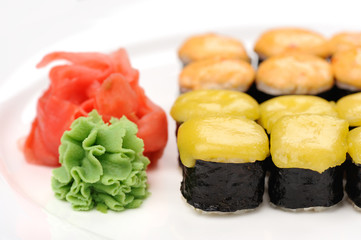 Baked cheese rolls set with wasabi and ginger on white plate