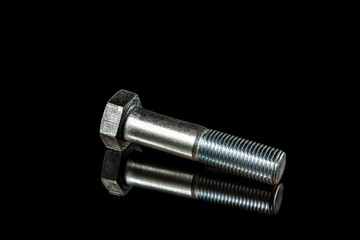 An isolated steel bolt on black background