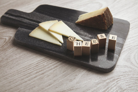 wooden letters side to goat cheese isolated