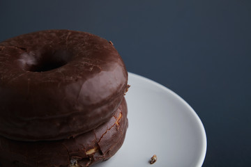 Two donuts isolated on corner table close up