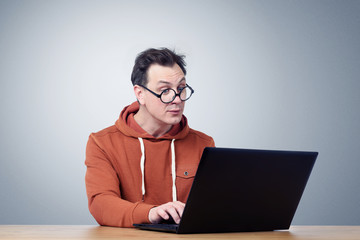 Programmer in glasses with laptop