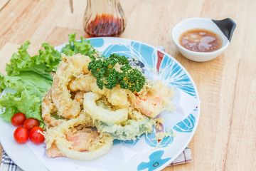 Japanese Food Tempura Mix ingredients are shrimp, carrot, pumpkin, eggplant and onion on wooden table.
