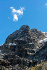 deserted summit of the rocky mountains under the sun and a blue sky with some snow in british columbia canada