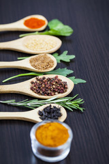Colorful spices and wooden cutlery