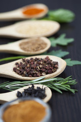 Colorful spices and wooden cutlery