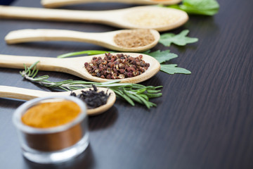 Colorful spices and wooden cutlery