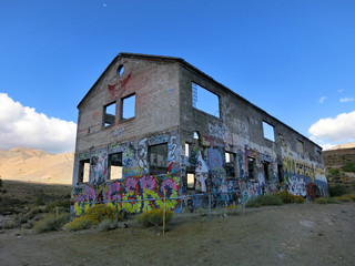Abandoned shell of a building with painted color exterior - landscape color photo