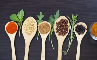 Colorful spices and wooden cutlery