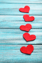 Red hearts on a blue wooden table