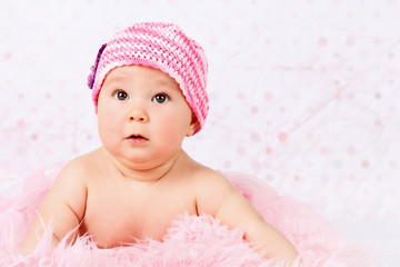 Beautiful little baby girl wearing pink knitted cap