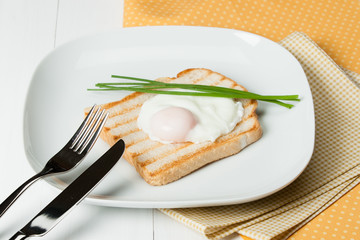 Poached Egg On Toast With Chives. White Plate