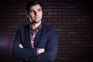 portrait of handsome man in jacket and plaid shirt