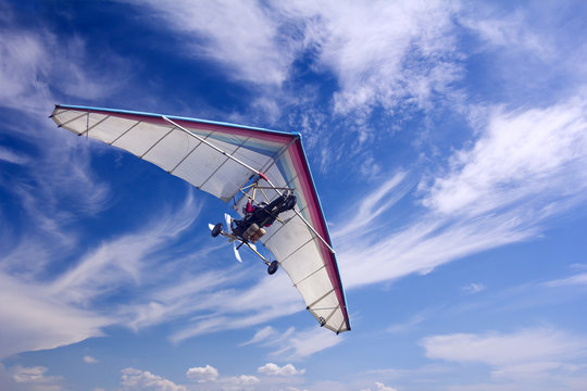 Motorizedr paraglider flying in the blue sky
