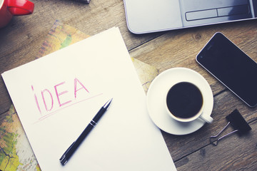 computer, phone, coffee, paper and pen