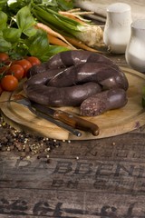 juicy and tasty black pudding on a dark brown planks 