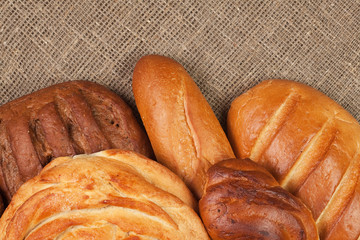 variety of fresh bread over sackcloth background