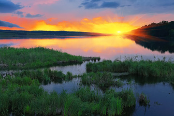 Naklejka na ściany i meble Beautiful summer sunset in the lake