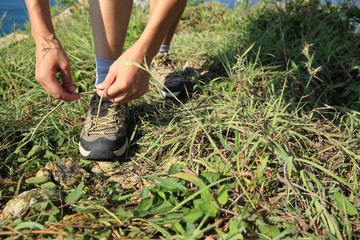 young woman hiker hiking on seaside mountain peak