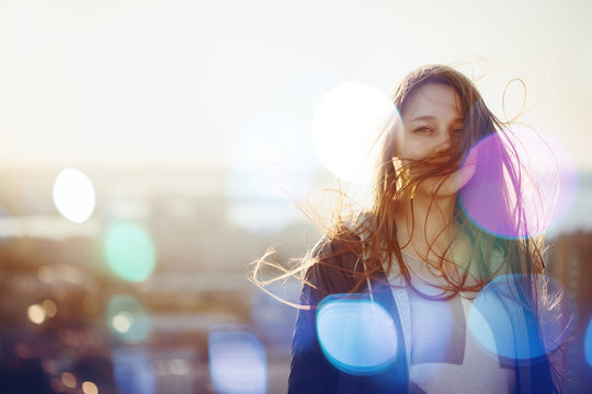 Young Woman Standing in Sunset Light