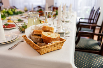 Bread in basket on banquet Table served in restaurant with tasty meals.