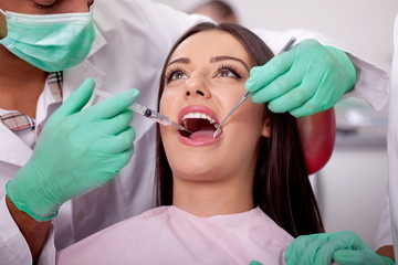 dentist giving anesthesia to the patient